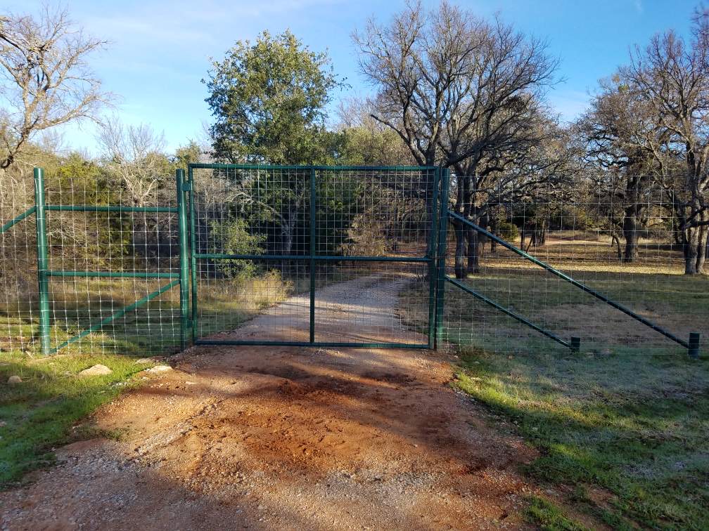 Wide metal equipment barn sheltering farm machinery — Brown County TX